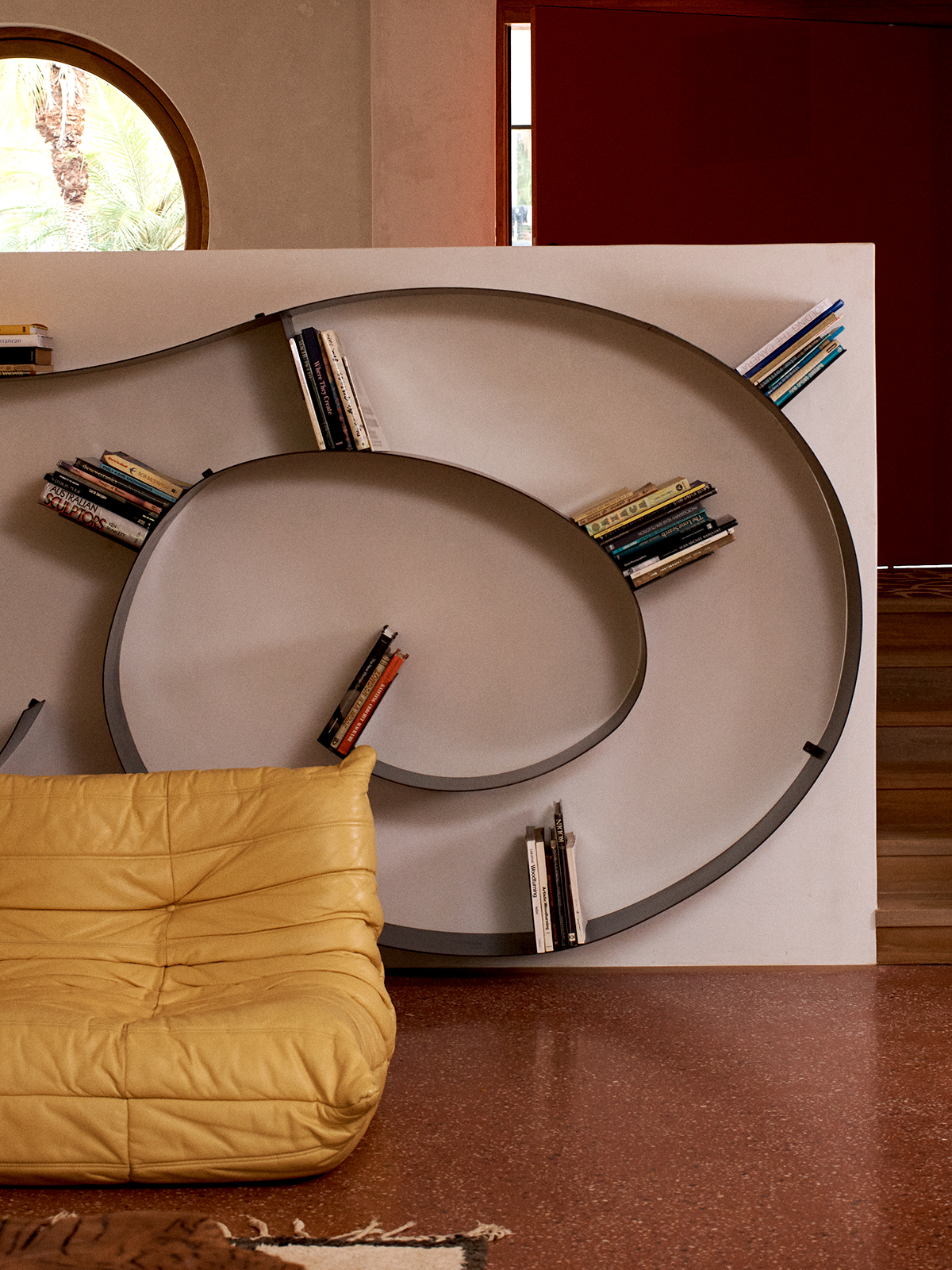 Library at The Sunseeker, Byron Bay; Eastern Forge spiral bookshelf; Tigmi Togo sofa (photo credit. James Tolic)